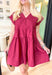 Steal A Kiss Dress, burgundy cap sleeve babydoll mini dress with tiers, pleating across the chest, and wrapped buttons going a quarters length down the front of the dress, v-neck line, pockets 