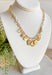 Talk About It Necklace, gold paper chain link necklace with a variation of gold charms with different details on them such as pearls, diamonds, and other designs 