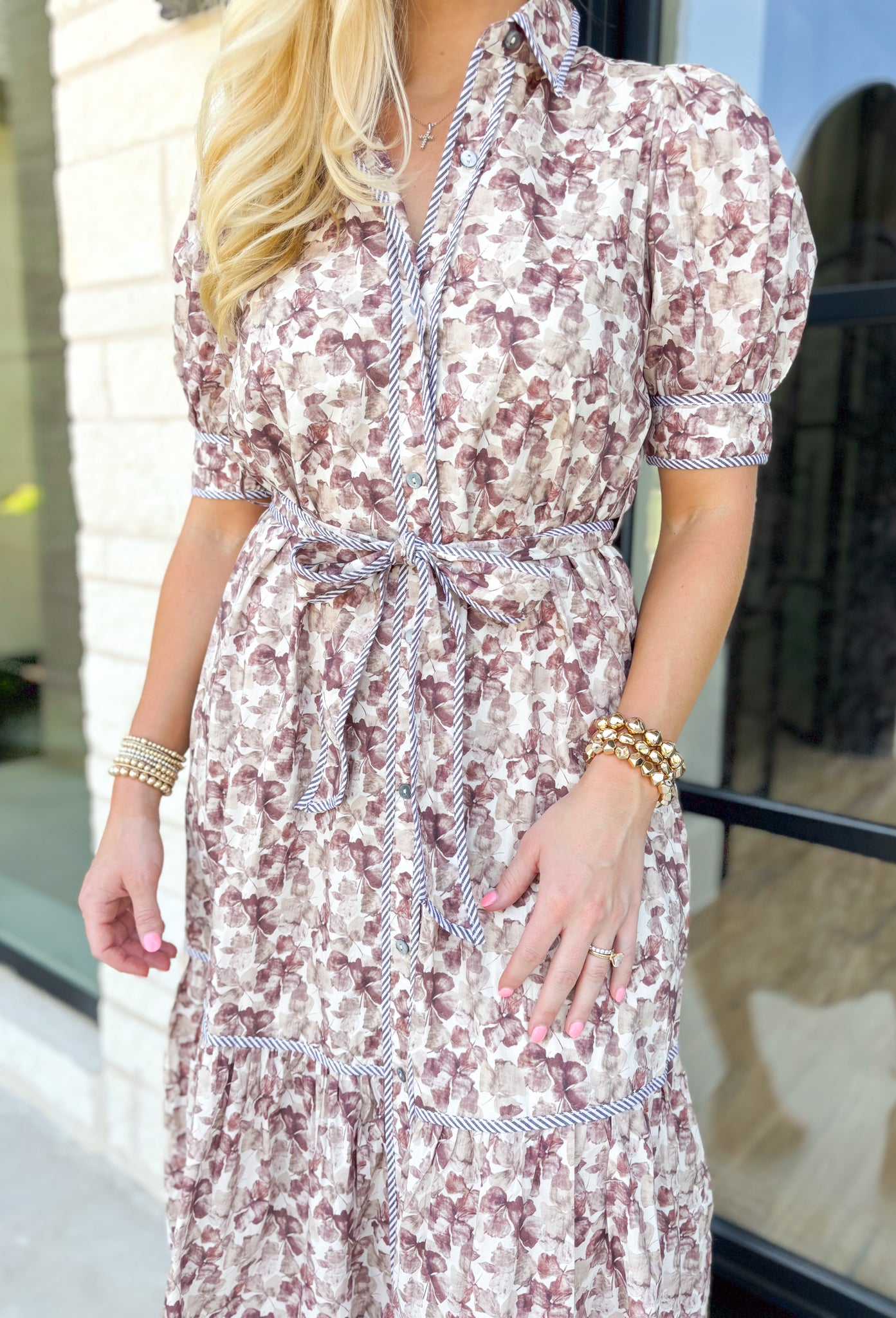 Talk Sweetly Midi Dress, midi dress with pressed flowers in hues of tans, taupes and cream with a puff sleeve, collar, and tiering detail. Tie belt at the waist.