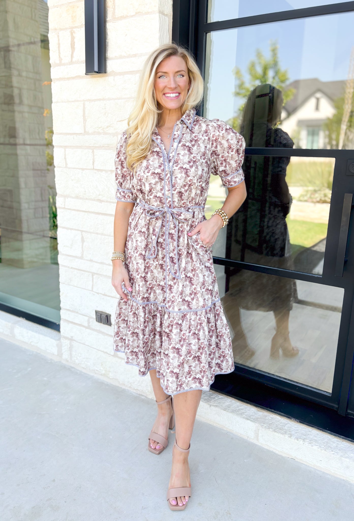 Talk Sweetly Midi Dress, midi dress with pressed flowers in hues of tans, taupes and cream with a puff sleeve, collar, and tiering detail. Tie belt at the waist.