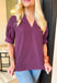 Tell Me The Truth Top, short sleeve blouse in a deep plum, stitch details on the sleeves and bottom of the blouse, v-neckline 