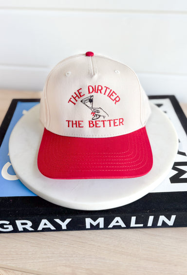 The Dirtier The Better Trucker Hat, red and cream trucker hat with red embroidered text "the dirtier the better" with a hand holding a martini in the center 