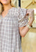 Trust Yourself Top, taupe, light blue, and white plaid puff sleeve blouse with ruffling on the shoulder and a v-neck line 