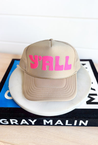 Y'all Trucker Hat, tan trucker hat with neon pink "y'all" in the center 