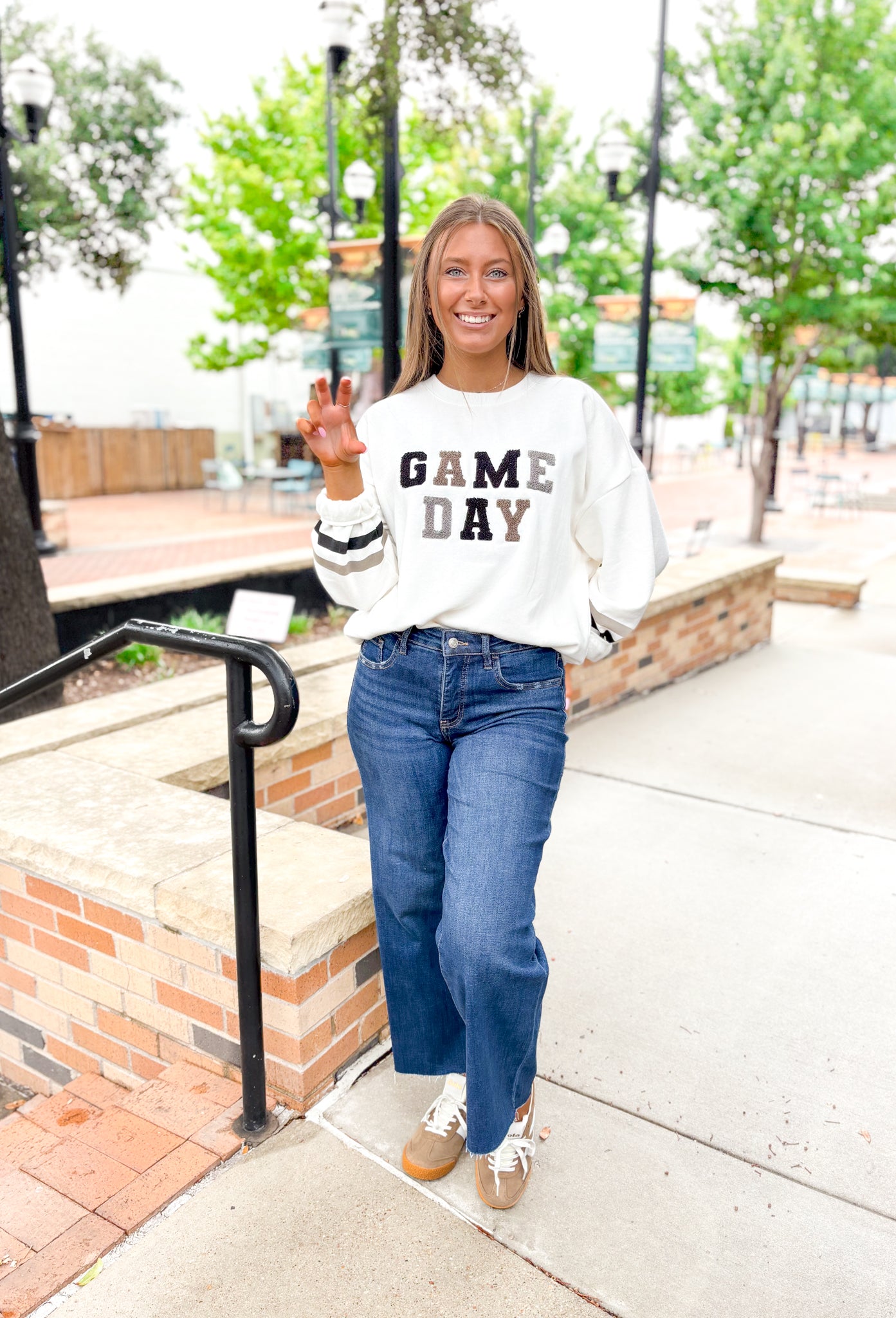 Z SUPPLY Oversized Game Day Sweatshirt in Bone, white crewneck with "game day" spelt out in black, gray, and taupe patches, sleeves have a taupe and black stripe on the wrist 