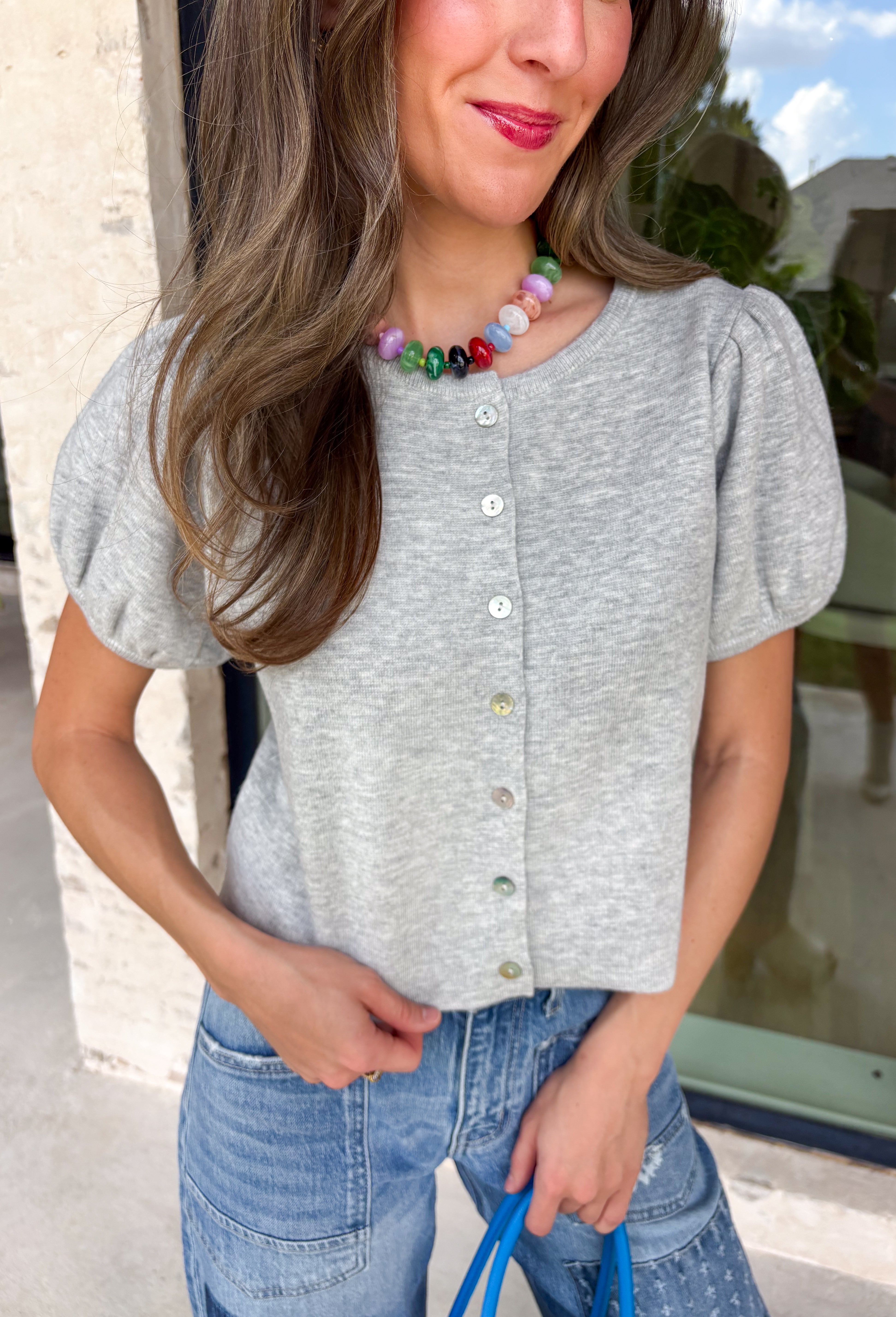 Meet the cardigan you'll be reaching for all season long! This heather grey knit is the definition of timeless style, combining a classic button-down silhouette with soft puff sleeves for a feminine touch. The cozy sweater knit feels warm without being bulky, making it perfect for layering through the fall months. Whether you're heading to the office, meeting friends for coffee, or relaxing on the weekend, this versatile cardigan is an effortless staple you'll wear year after year.