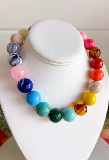 Bring on the sunshine and color! This chunky beaded necklace is the ultimate summer statement piece. Featuring a vibrant mix of colorful beads, it instantly adds a fun, playful touch to any outfit. Whether you're styling it with a simple tank, a breezy sundress, or your favorite vacation look, this necklace does all the heavy lifting. The chunky design keeps it right on trend, while the cheerful colors make it impossible not to smile. 