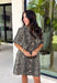 Classic denim meets a timeless animal print in this effortlessly stylish dress. This neutral leopard print denim dress is the perfect balance of bold and versatile. The button-front design and short sleeves give it an easy, everyday feel, while the front patch pockets and side pockets add both charm and function. Crafted from a soft cotton blend with just the right amount of stretch, this dress is made for everything from casual weekends to lunch dates and fall adventures.