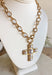 This chunky gold chain necklace makes a bold yet timeless statement. Featuring a gold cross adorned with pearls, it blends modern edge with classic elegance. The toggle clasp closure adds a stylish touch while keeping it easy to wear. Perfect for elevating casual looks or adding a refined accent to dressier outfits.