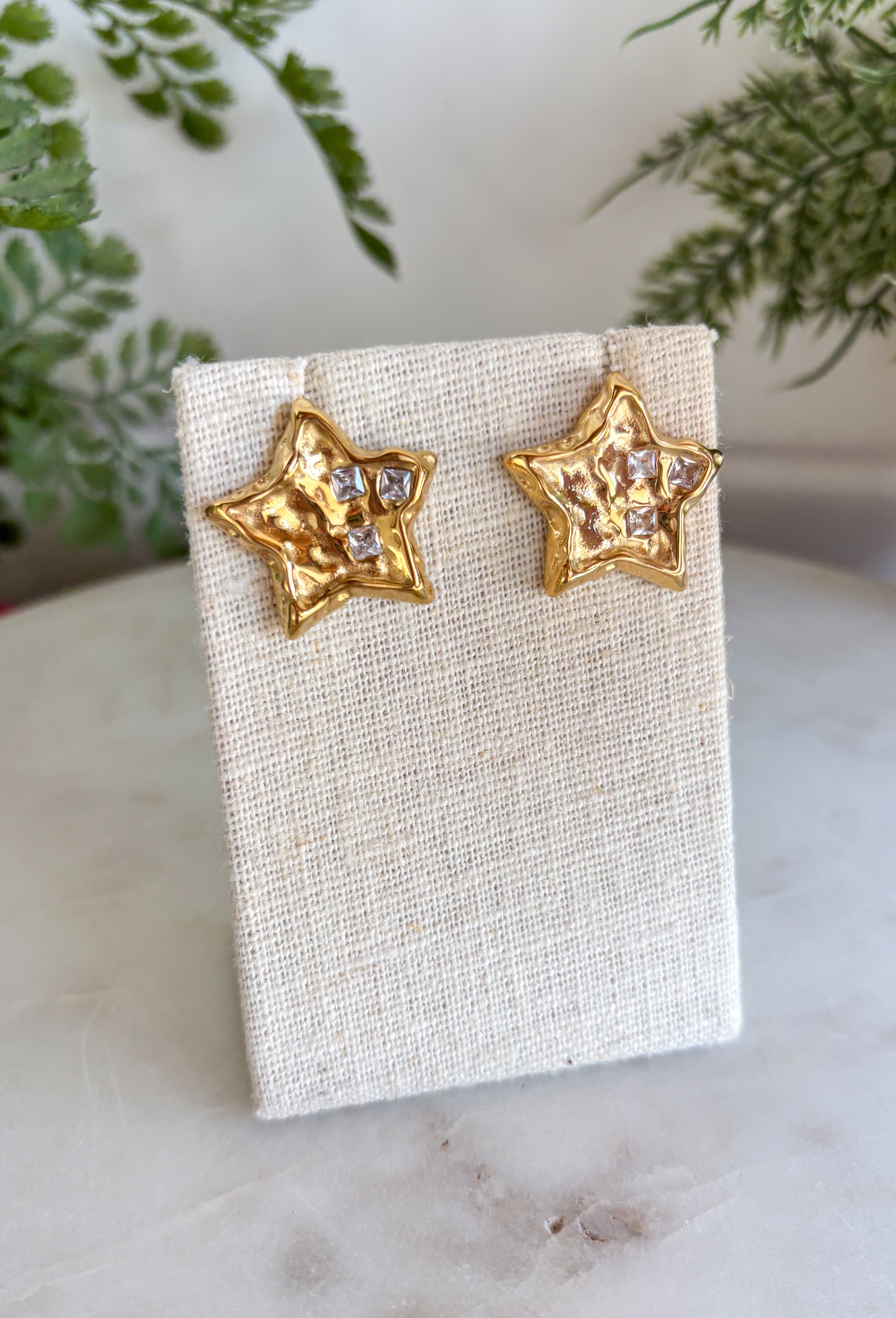 Bring a little sparkle and timeless charm to your jewelry collection with these dazzling star stud earrings. Crafted in a classic gold finish, each petite star is adorned with shimmering crystal accents that beautifully catch the light from every angle. Their classic design makes them perfect for everyday wear while adding just the right amount of shine to special occasions. Lightweight, comfortable, and endlessly versatile, these earrings are a must-have accessory you'll reach for again and again.