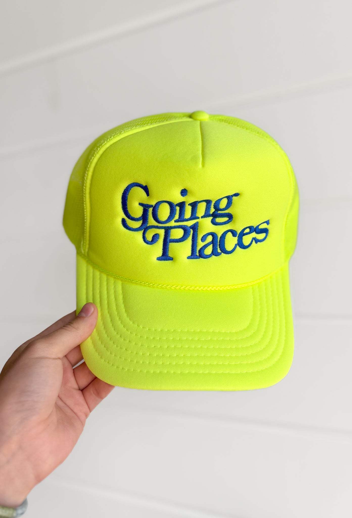 Friday + Saturday: Going Places Trucker in Yellow, neon yellow trucker hat with "going places" embroidered in royal blue