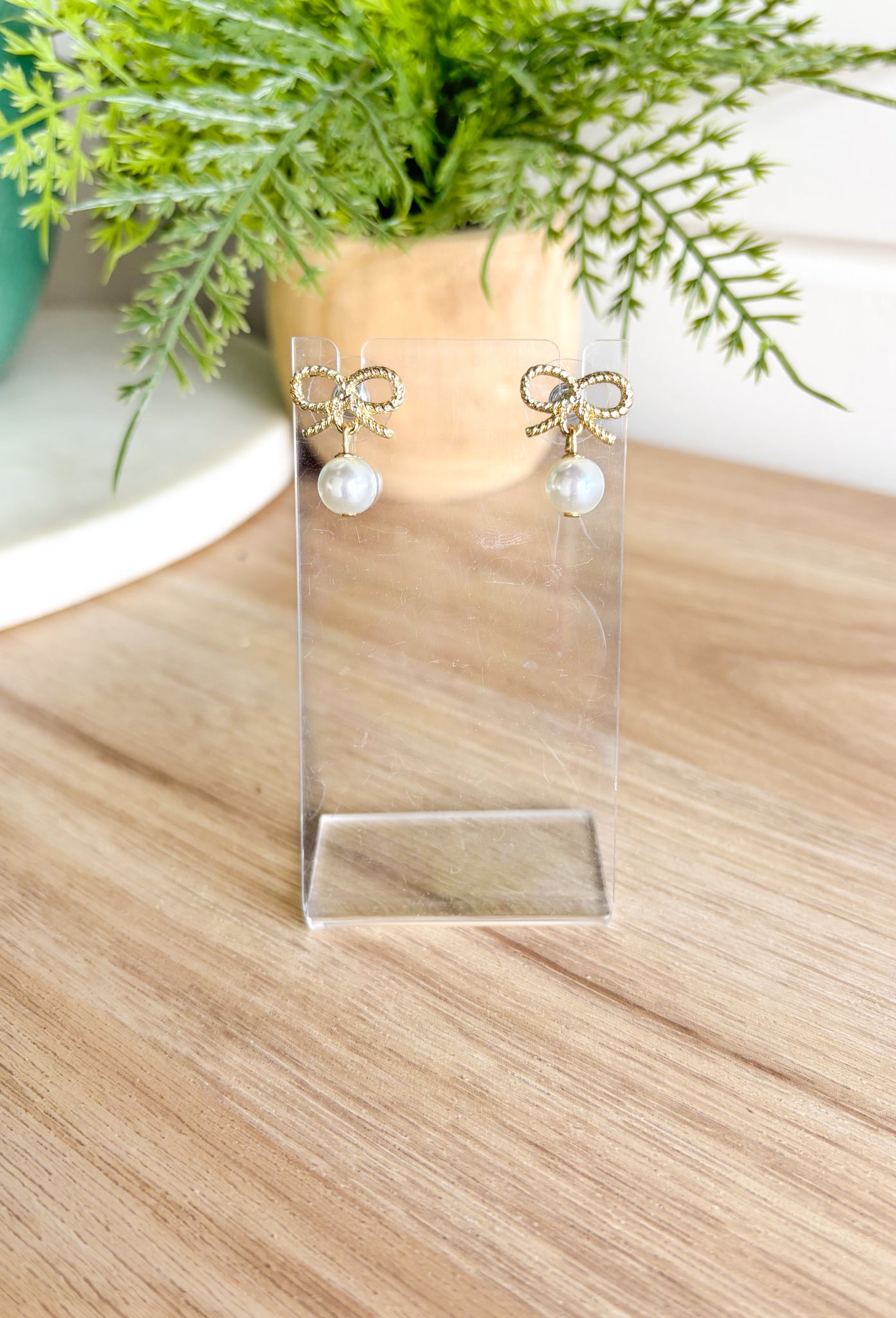 Here With Me Earrings, small textured gold bow post back earrings with pearl attached to the bottom 