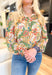 Last Chance Floral Blouse, long sleeve blouse with palm leaves and flowers, smocking on the wrist, quarter button down detail, in the colors amazon green, yellow, cream, orange, aqua, fuchsia, gold detail throughout the blouse