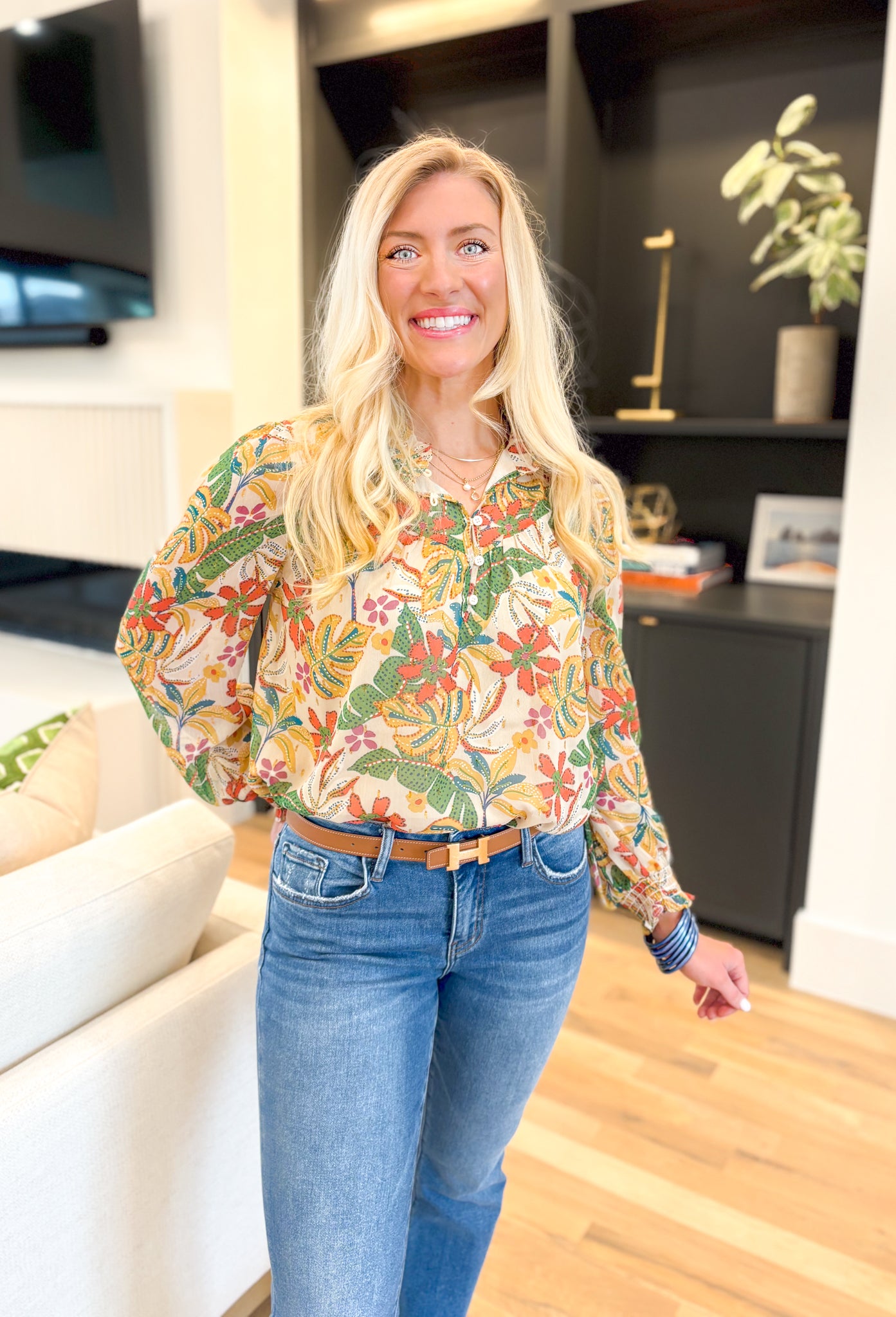 Last Chance Floral Blouse, long sleeve blouse with palm leaves and flowers, smocking on the wrist, quarter button down detail, in the colors amazon green, yellow, cream, orange, aqua, fuchsia, gold detail throughout the blouse