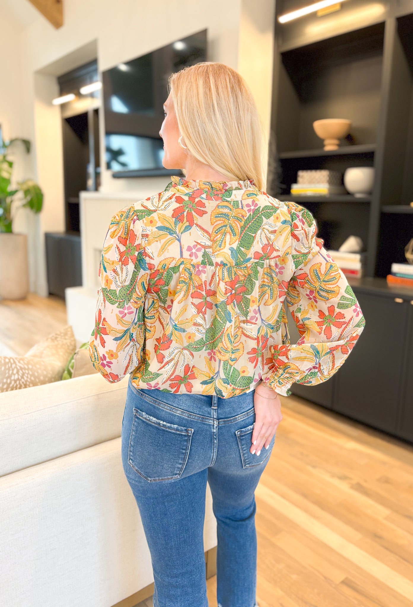 Last Chance Floral Blouse, long sleeve blouse with palm leaves and flowers, smocking on the wrist, quarter button down detail, in the colors amazon green, yellow, cream, orange, aqua, fuchsia, gold detail throughout the blouse