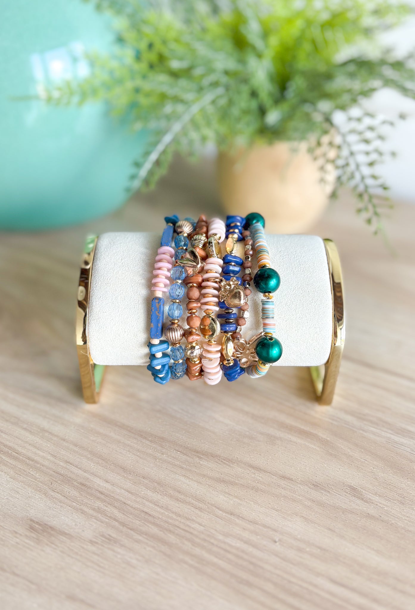 Make A Change Bracelet Set, stack of 7 beaded bracelets in different styles and textures in the colors blue, green, pale pink, cognac, sand, and gold