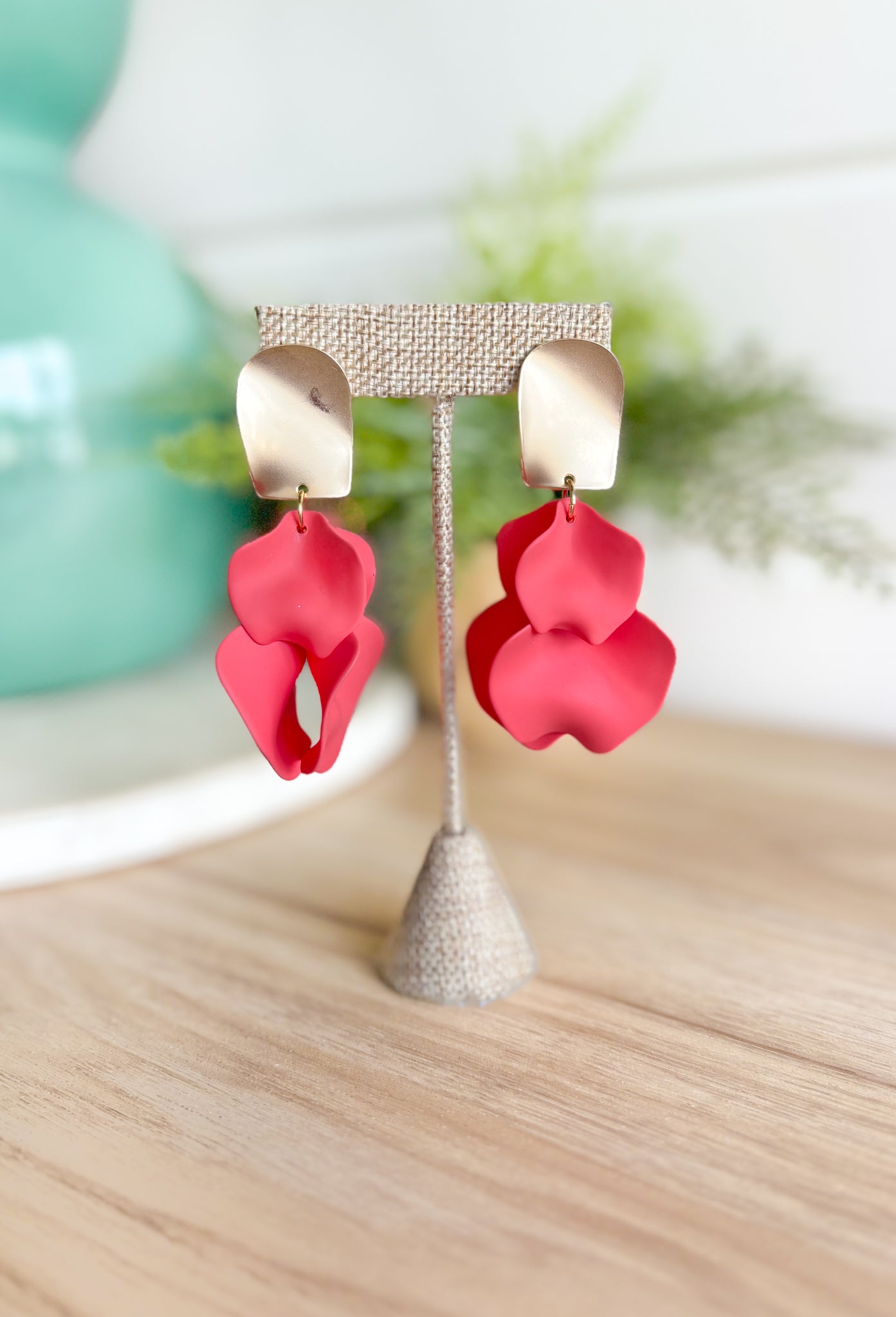 Never Better Earrings, matte gold rectangle post back earring with clay petals hanging off the bottom in a pomegranate color  