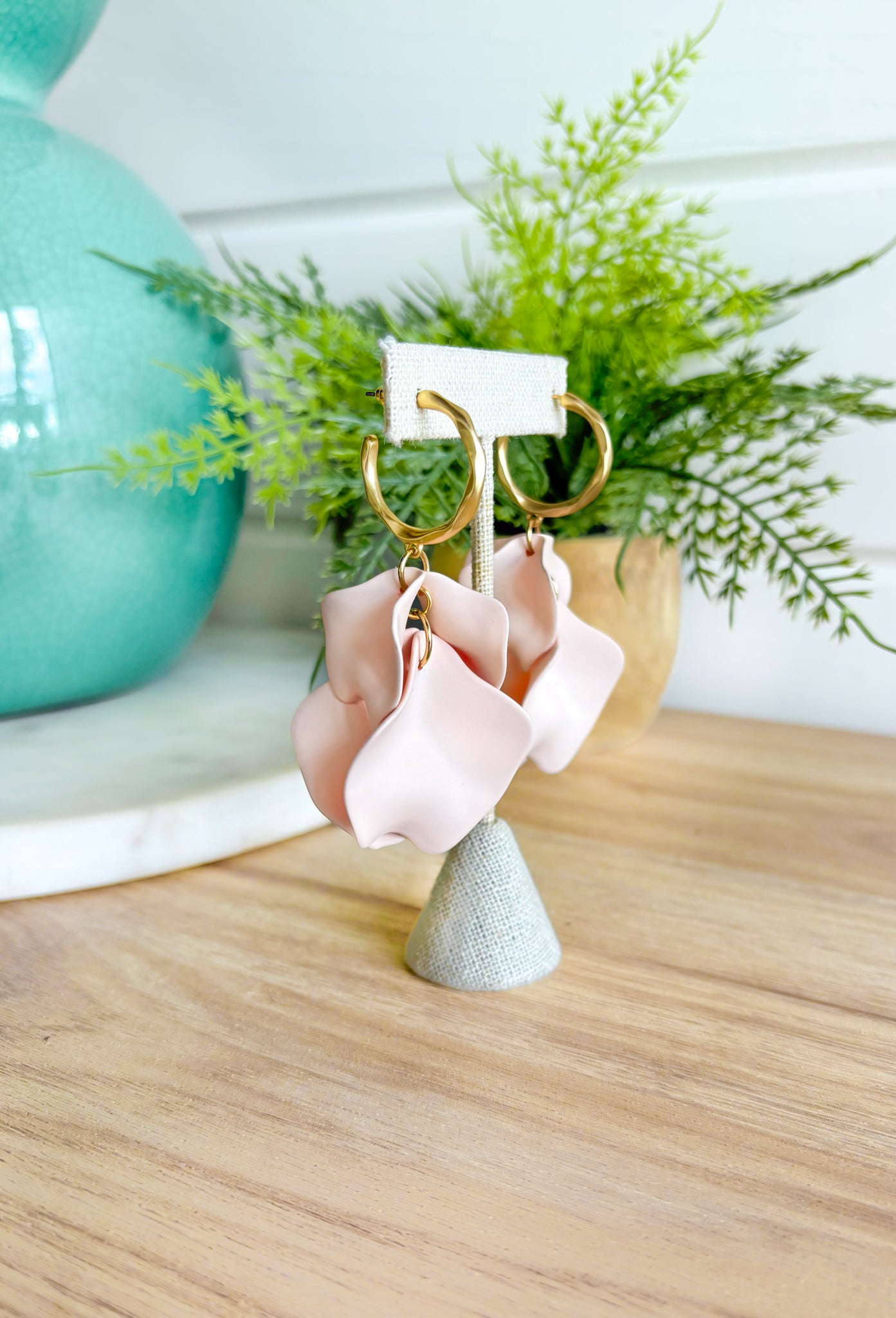 Up To You Earrings, matte gold hoop earrings with clay petals hanging off the bottom 