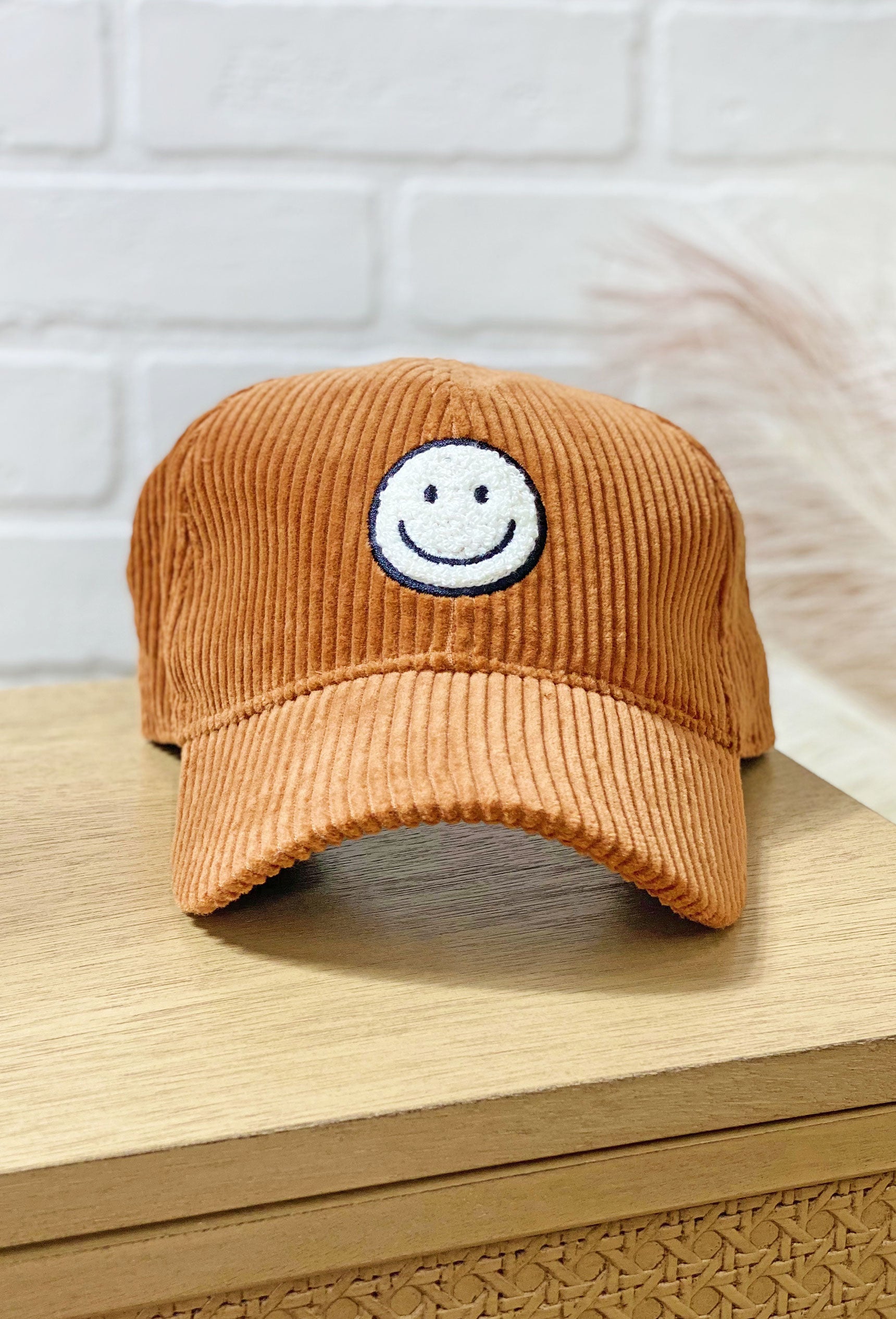 All Smiles Corduroy Hat in Brown, brown corduroy hat with smiley face patch